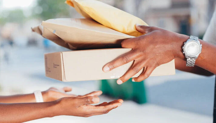 A woman taking prescription delivery from her door